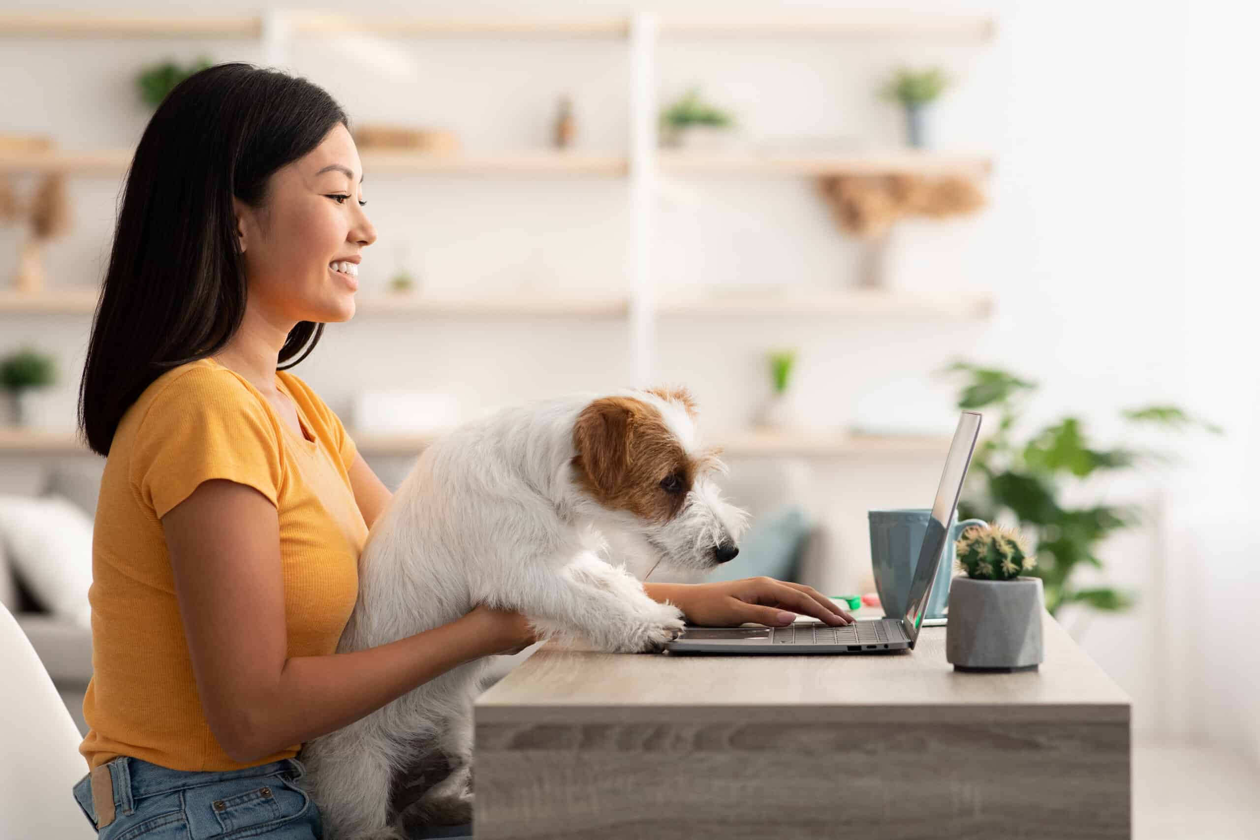 girl working remotely with her dog