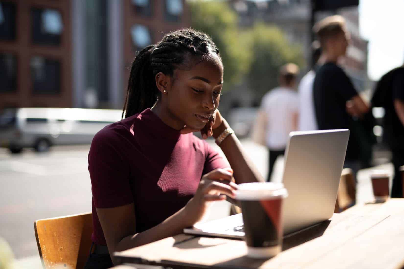 woman working remotely from a cafe